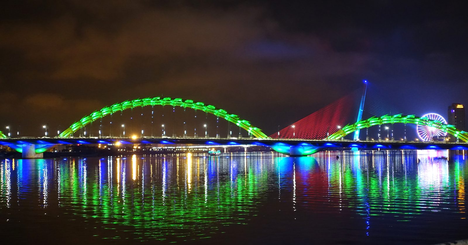 Dragon Bridge illuminated above the Han River in Da Nang at night